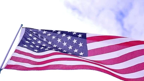 A close up of an American flag blowing on a flagpole. Stock Footage 124939532