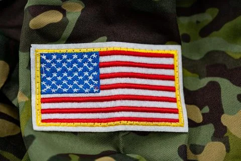 Close up of American flag patch on camouflage military uniform Stock Photos