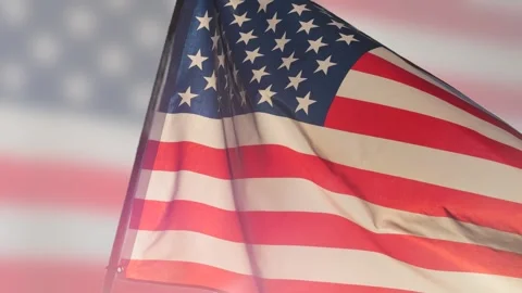 Close up American flag waving against on blurry American flag background Stock Footage 336979069