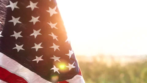 Close up American flag waving on sunset with soft focus, Slow Motion. Stock Footage 142749752