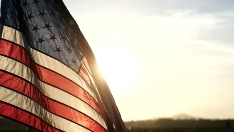 Close-up American flags waving over sunset or sunrise in nature background Stock Footage 154917341