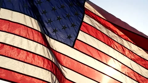 Close-up American flags waving over sunset or sunrise in nature background Stock Footage 154917344