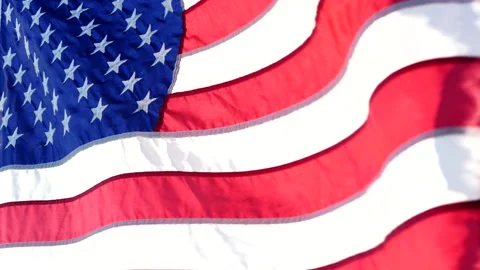 Close-up American flags waving over sunset or sunrise in nature background Stock Footage 154917382