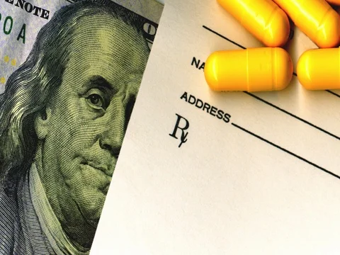 Close-up of American one hundred dollar bill, prescription and pills. Stock Footage 76003928
