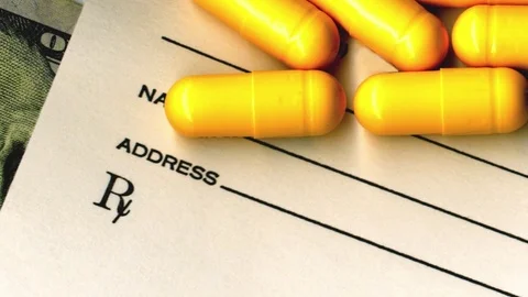 Close-up of American one hundred dollar bill, prescription and pills. Stock Footage 79976797