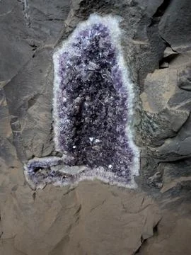 Close-up of an amethyst geode embedded in basalt rock. Vanda mines in Misio.. Stock Photos
