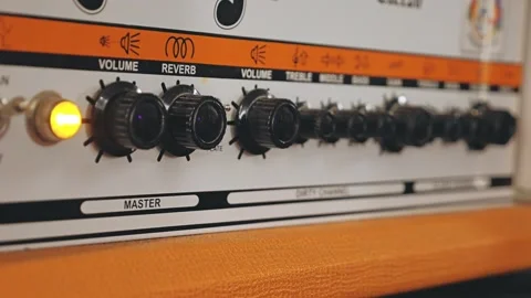 Close-up of an amplifier control panel featuring various knobs for volume 스톡 동영상 316780583