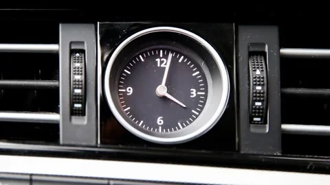 Close-up of an analog clock on a car interior dashboard spinning rapidly Stock Footage 325697199