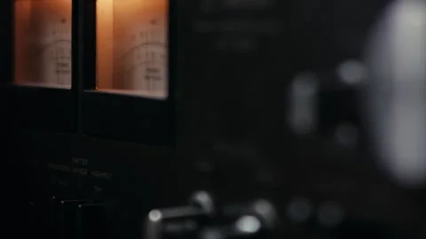 Close-Up on Analog VU Meter of Vintage Audio Amplifier Moving in Sync to Music Stock Footage 131025514