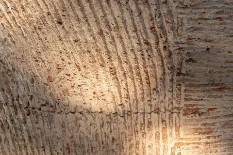 Close-up of an ancient arched ceiling with rough, textured brick and mortar. Stock Photos