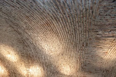 Close-up of an ancient arched ceiling with rough, textured brick and mortar. Stock Photos