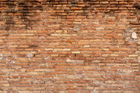 Close-up of ancient brick wall with rough surface and earthy colors, highli.. Stock Photos