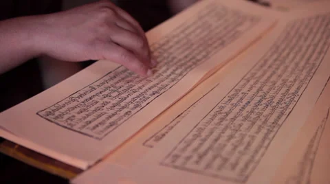 Close up of ancient Buddhist script being read inside in Gompa. 스톡 동영상 31842747