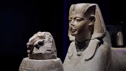 Close-up of an ancient Egyptian pharaoh statue displayed in a museum, featuring Stock Footage 333458381