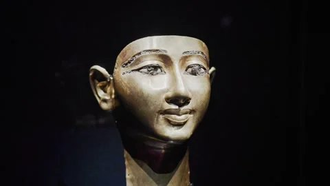 Close-up of an ancient Egyptian queen bust under dramatic lighting Stock Footage 333458045