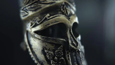 Close up of ancient gladiator helmet spinning on a turntable, wet metallic Stock Footage 334139957