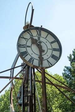 Close-up of an ancient iron clock tower on a sunny summer day Stock Photos