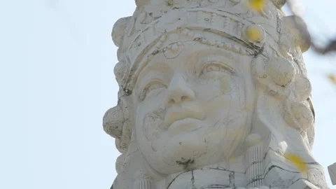 Close Up of Ancient Stone Buddha Statue Against Blue Sky Stock Footage 324559939