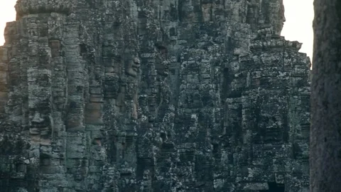 Close up Ancient stone faces carved into towers of Bayon Temple at Angkor T.. 스톡 동영상 318637871