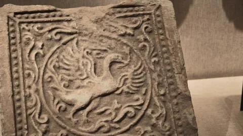 Close-up of Ancient Stone Relief Depicting Mythical Bird with Swirling Patterns 库存影片 340466713