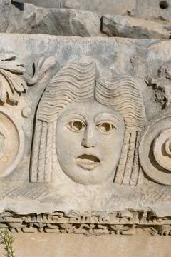 Close-up of an ancient stone relief featuring a detailed carving of a female  Foto stock