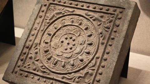 Close-up of Ancient Stone Relief Tile with Intricate Circular Carvings 스톡 동영상 340466692