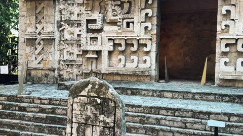 Close-up of an ancient stone wall featuring decorative Mesoamerican carvings at Stock Footage 333777677