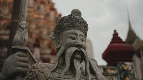 Close up of an ancient stone warrior statue guarding a traditional thai buddhist Video stock 346642886