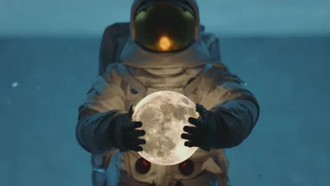 Close up of and astronaut in space suit holding and dropping the moon Dark sci Stock Footage 219928356
