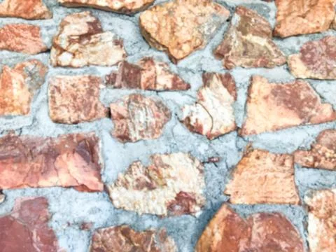 Close up and blurring of the old patterned stone wall and has cement to kee.. Stock Photos