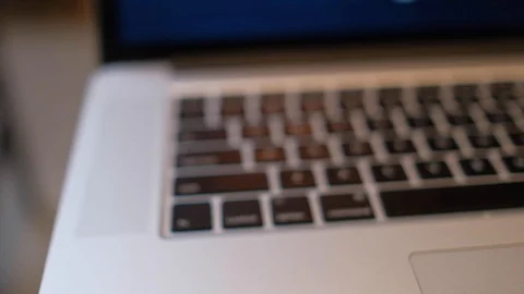 Close-up and defocus of laptop keyboard with focus buttons key Stock Footage 98978634