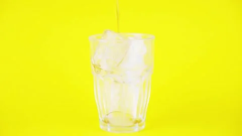 Close up and fill serving a liquid glass of cola on a yellow background. Stock Footage 131826843
