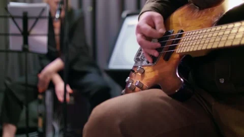 Close up and focused view of man playing the guitar. Small concert in friendly Stock Footage 146545392