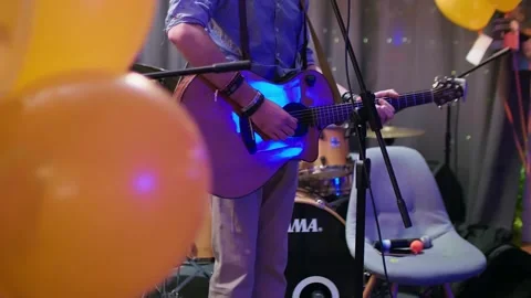 Close up and focused view of man playing the guitar. Small concert in friendly Stock Footage 146545666