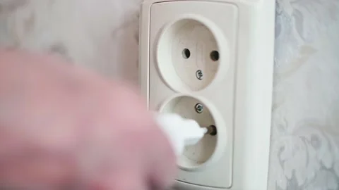 Close up and focused view of white socket where white plug is being inserted Video stock 153556827