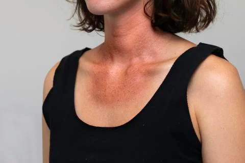 A close up and front view of a young caucasian woman wearing a black vest top Photos