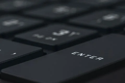 Close-up and full view of a modern computer keyboard, enter key Stock Photos