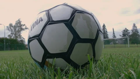 Close up and low perspective of a soccer ball laying in the grass Stock Footage 153378103