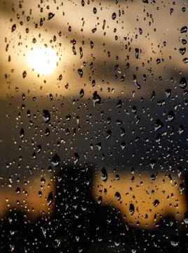 Close up and macro view of raining water drop on clear transparent glass and Stock Photos