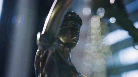 Close up and medium Lady Justice blindfolded and holding balance scales and a sw Stock Footage 118007300