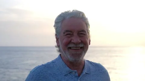 Close up and portrait of mature old man smiling and laughing looking at the came Stock Footage 135683409