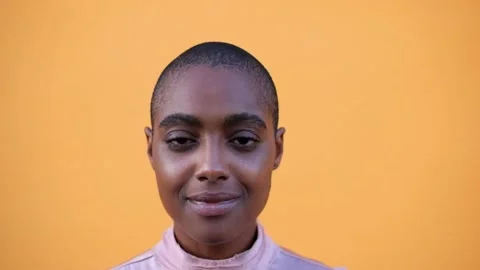 Close up and portrait of one young and beautiful afro American woman looking at  Stock Footage 139752999