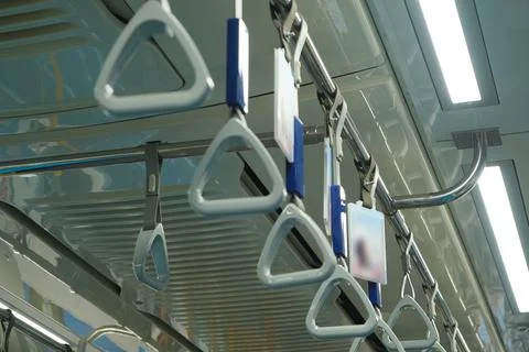 Close up and selective focus of grey triangle handle bar in the train. Photos