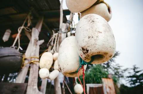 Close up and selective focus. group of dirty white fish net buoy tied with ro Fotos Stock