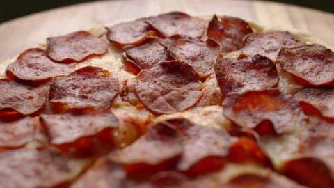 Close up and selective focus of Pepperoni pizza on wooden table Stock Footage 309123112