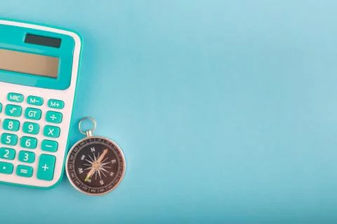 Close-up and selective focus shot, calculator and compass on wooden desk Stock Photos