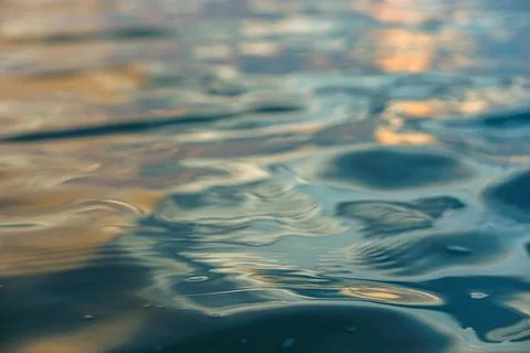 Close-up and selective focus view of sunlight reflection in water at sunset Stock Photos