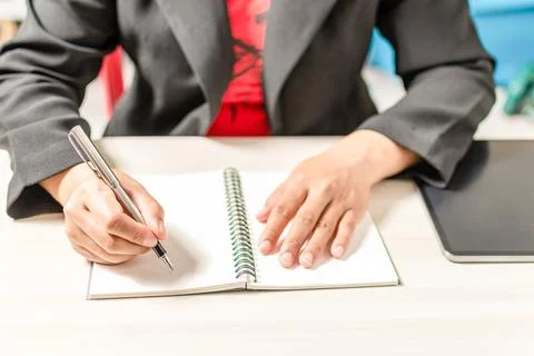 Close-up and selective focus of a woman's handwriting with a notebook Stock Photos