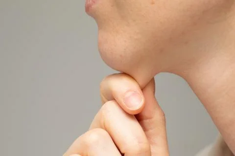A close-up and side profile view of a young Caucasian woman pinching the laye 스톡 사진