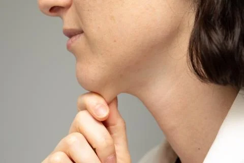 A close up and side profile view of a young Caucasian lady pinching the skin  Photos